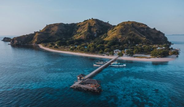 Aerial view of a scenic island with a pier in East Nusa Tenggara, Indonesia.