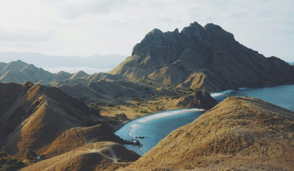 A breathtaking aerial shot of Padar Island's rugged landscape and serene beaches in Indonesia.